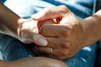 person wearing gold wedding band by National Cancer Institute courtesy of Unsplash.